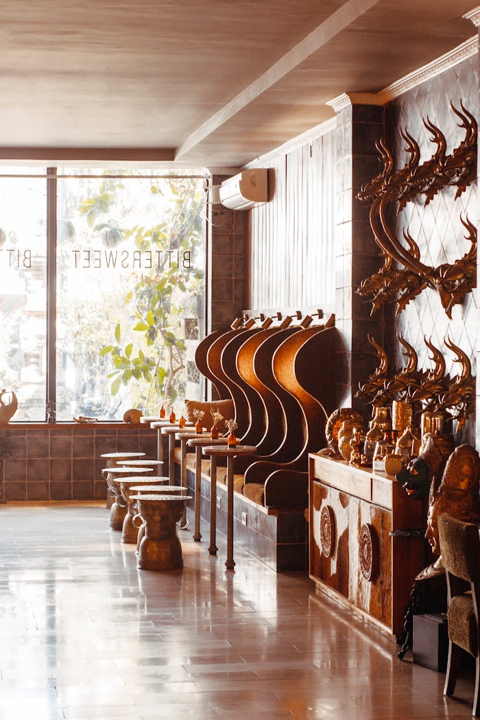 A modern lounge featuring unique wooden decor, trophy displays, and artistic wall designs.